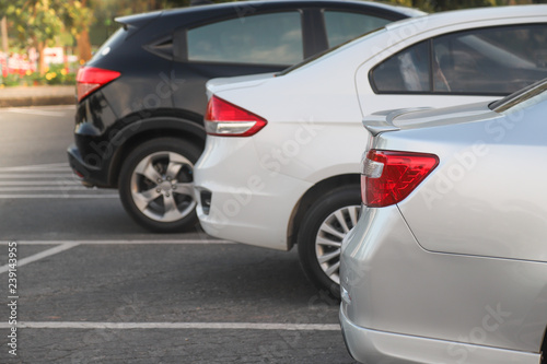 Closeup of rear side of bronze car parking in parking lot. © Amphon