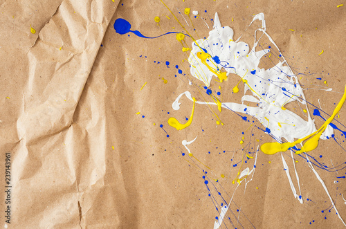 White and blue and yellow blemish on the paper
