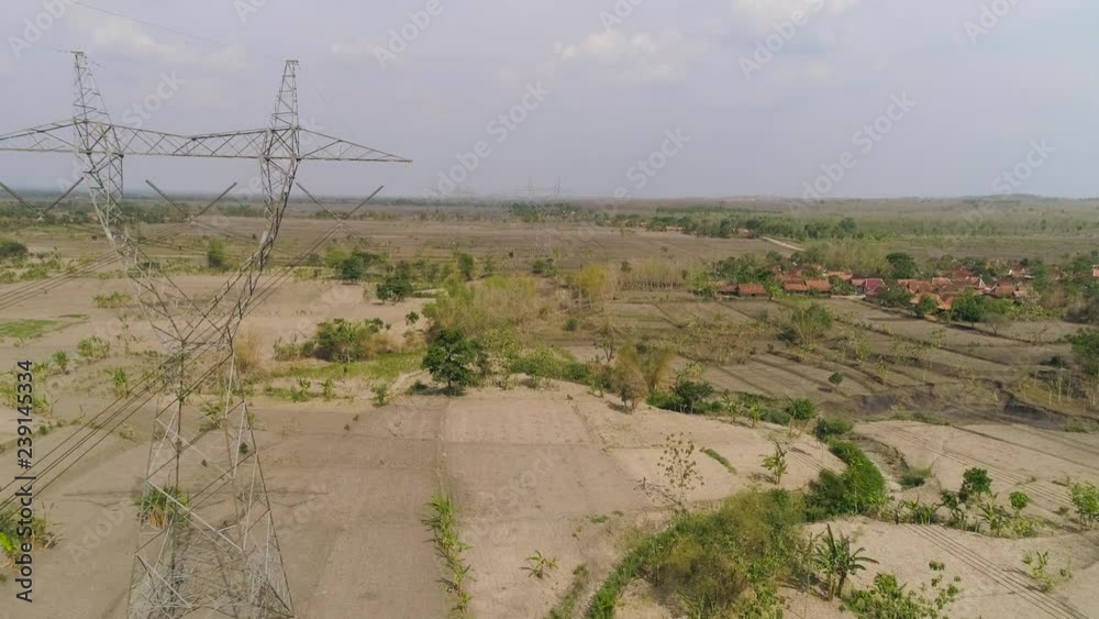 Electricity pylons bearing power supply across rural landscape. aerial ...