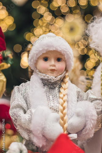 Christmas girl dolls, snow maiden for presesents or decoration, carry gifts sale, market, realization in the shop