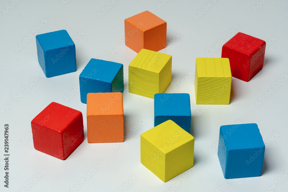 Obraz premium Colorful wooden childen's building blocks scattered loose
