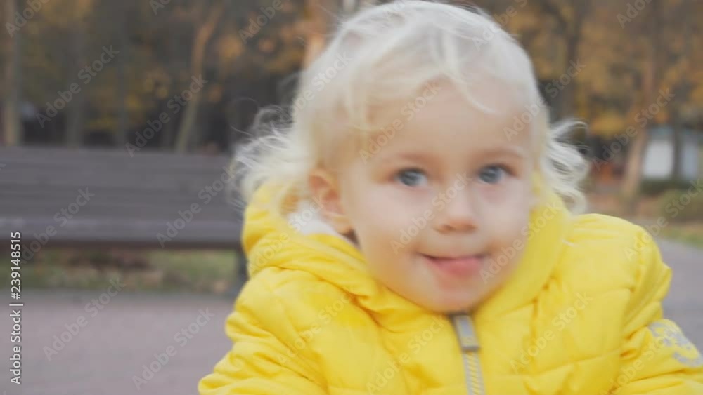girl child shows tongue, outdoor portrait on nature in park girl child shows tongue, outdoor portrait on nature in park