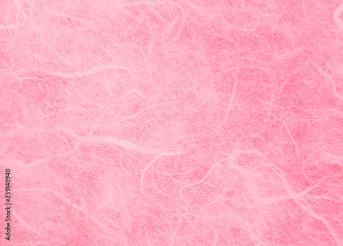Pink handmade mulberry paper texture background.Natural rough rice craft sheet textured pattern close up.Selective focus.