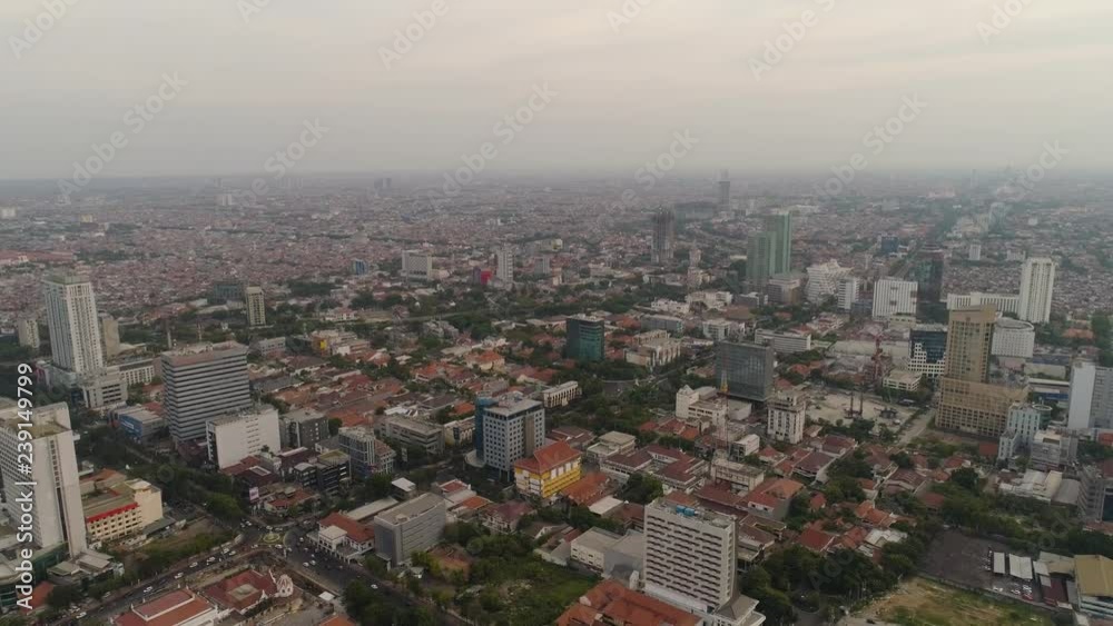 Aerial cityscape modern city Surabaya with skyscrapers, buildings and houses. sunset in city skyline with skyscrapers and business centers Surabaya capital city east java, indonesia