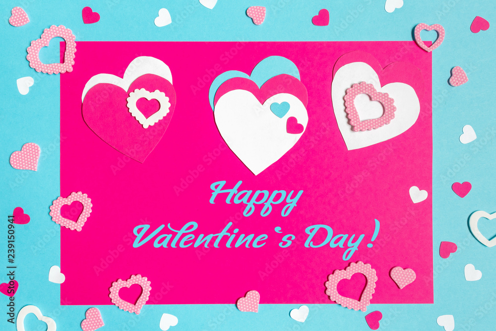 Valentine s Day greeting card. 14th of february. Happy Valentines Day Lettering with cut paper hearts on blue pink background with text happy valentines day
