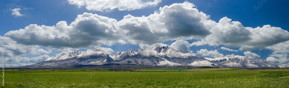 Extra wide panorama of High Tatra mountains during April with snowy hills Vysoke Tatry Slovakia