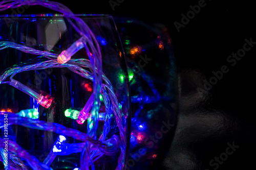LED colorful bulbs in a Wine Glass on a black background. Macro view.