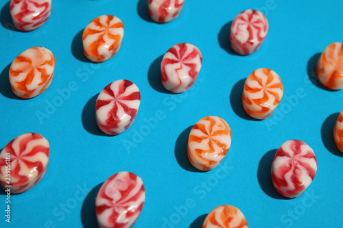 Different delicious colorful candies on color background