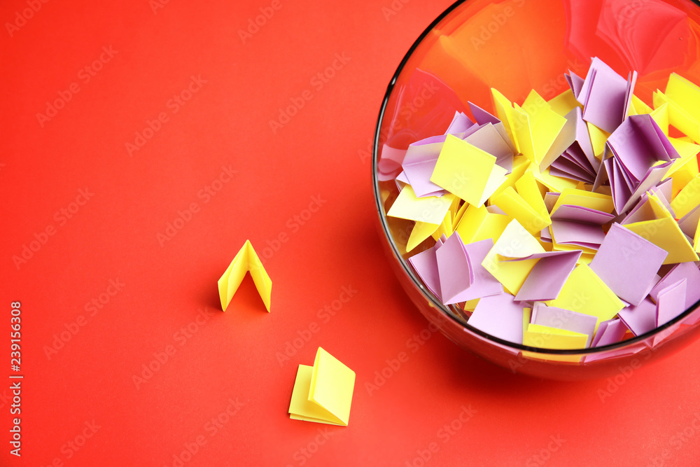 Paper pieces for lottery in glass vase on color background. Space for text - obrazy, fototapety, plakaty 
