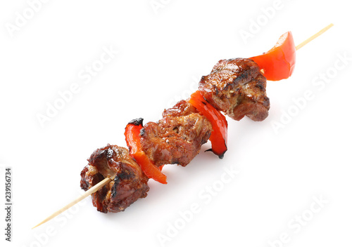 Skewer with delicious barbecued meat and pepper on white background