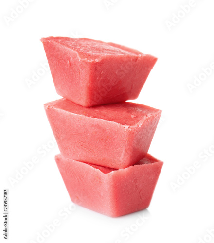 Tasty berry ice cubes on white background