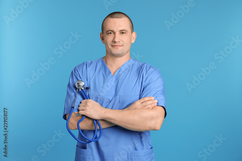 Portrait of medical assistant with stethoscope on color background