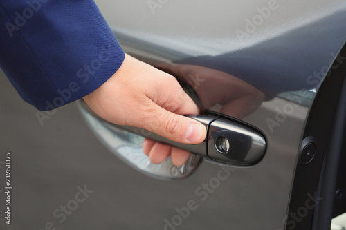 Closeup view of man opening car door