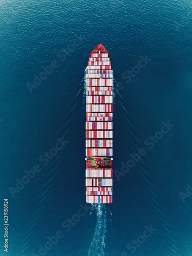 Aerial top view container ship on the sea full load container for import export, shipping or transportation. © Pawinee