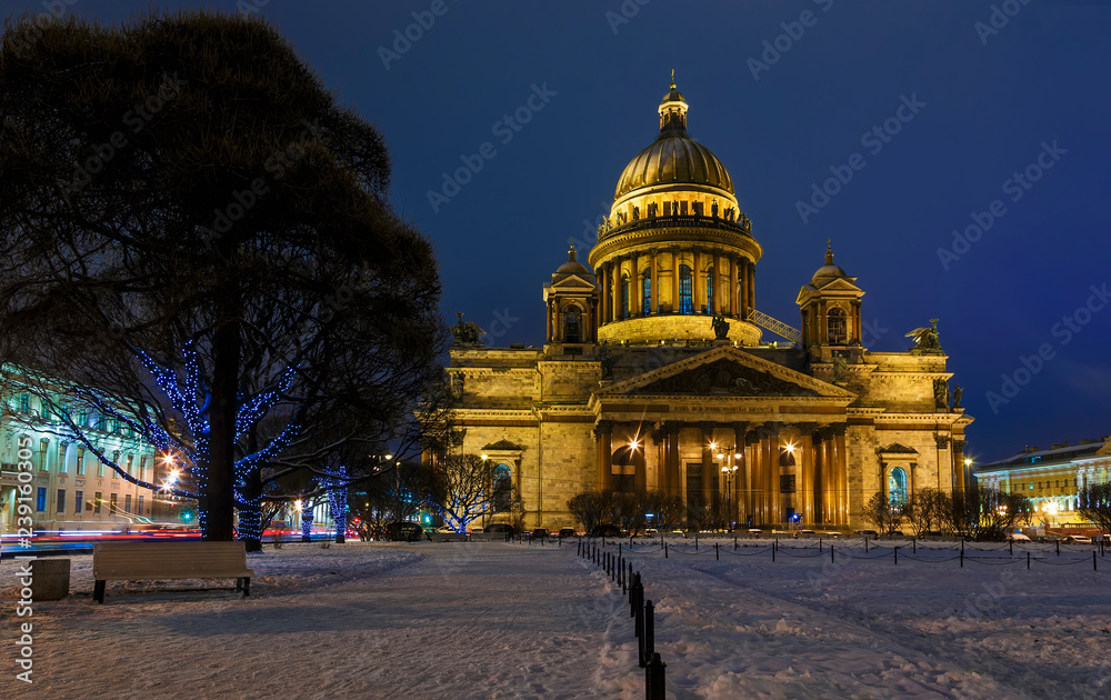 St. Isaac's Cathedral and lanterns decorated trees in the square in winter in St. Petersburg