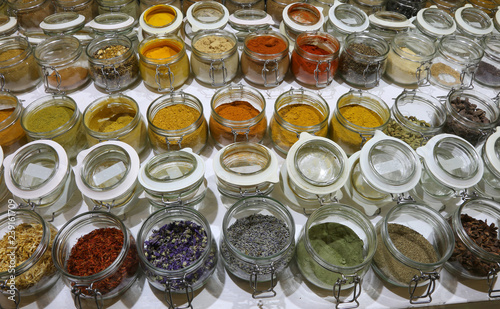 jars with spices and dried aromatic herbs gathered all over the