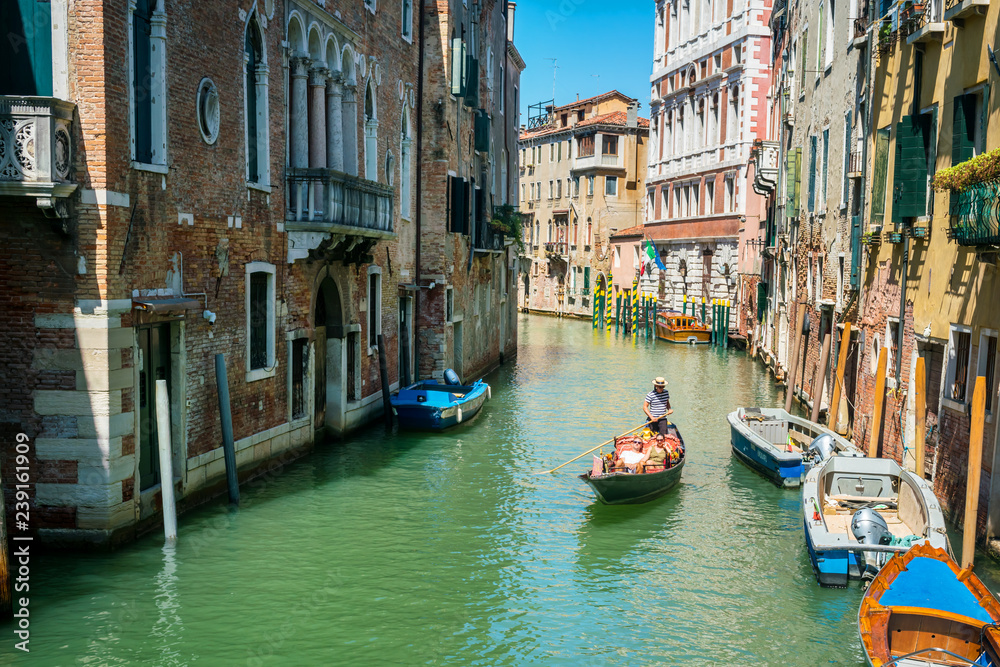 Venice, Italy, August 14, 2018: Gondolas on the canal in Venice