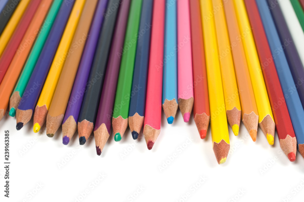 Colored pencils in a row isolated on white background. Colored pencils in a row isolated on white background.