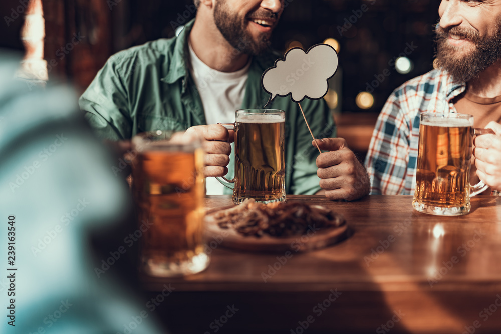 Cheerful friends with drinks spending time at pub