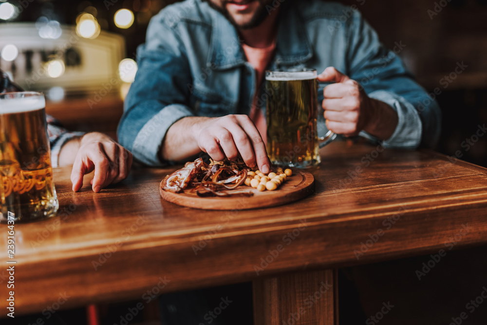 Friends enjoying drinks and snacks while spending time at pub