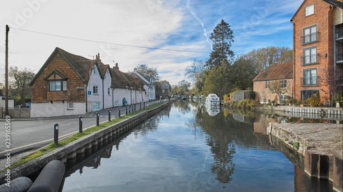 Houses and cottages on the towpath of the Kennet and Avon Canal, with a narrow boat approaching