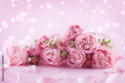 Beautiful rose flowers on pink background. Greeting card or banner for Womens day or Mothers day.