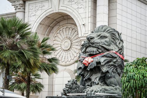 big black lion statue front of building.