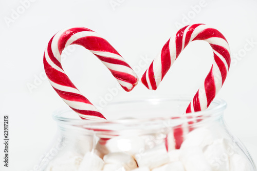 sugar candy in the shape of a heart in a jar of marshmallows, closeup