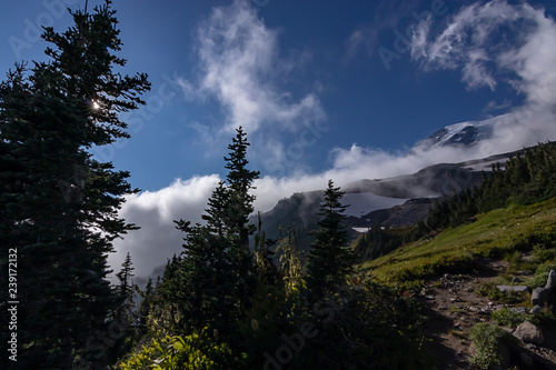 dark shodows on a mountain landscape below a blue sky photo