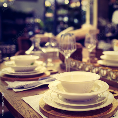 Dinner set up - Image. Table served for luxury dinner party with white plates, napkins, glasses, candles.