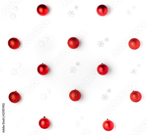 Christmas or winter composition. Pattern made of red balls and white snowflakes on white background. Christmas, winter, new year concept. Flat lay, top view, copy space