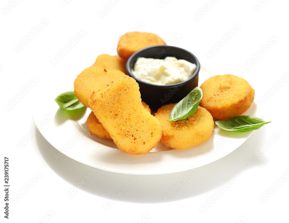 Fried chicken nuggets with white sauce and basil leaves on a white background. Fried chicken nuggets with white sauce and basil leaves on a white background.