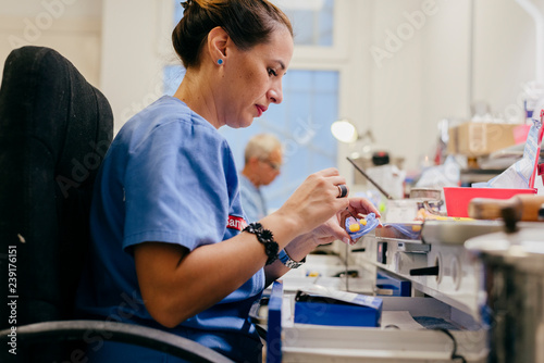Caucasian woman working on a dental prosthesis photo