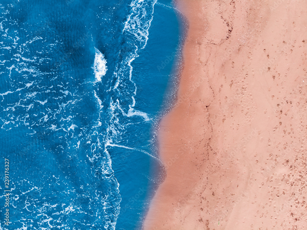 Concept Yin Yang. Sandy beach is washed by blue water. Top view