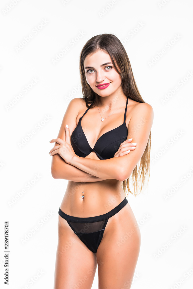 Young brunette woman posing in a black bikini isolated on white background