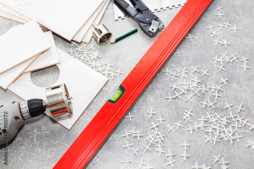 Ceramic tiles and tools for tiler, tiles installation. Home improvement, renovation - ceramic tile floor adhesive, mortar, level