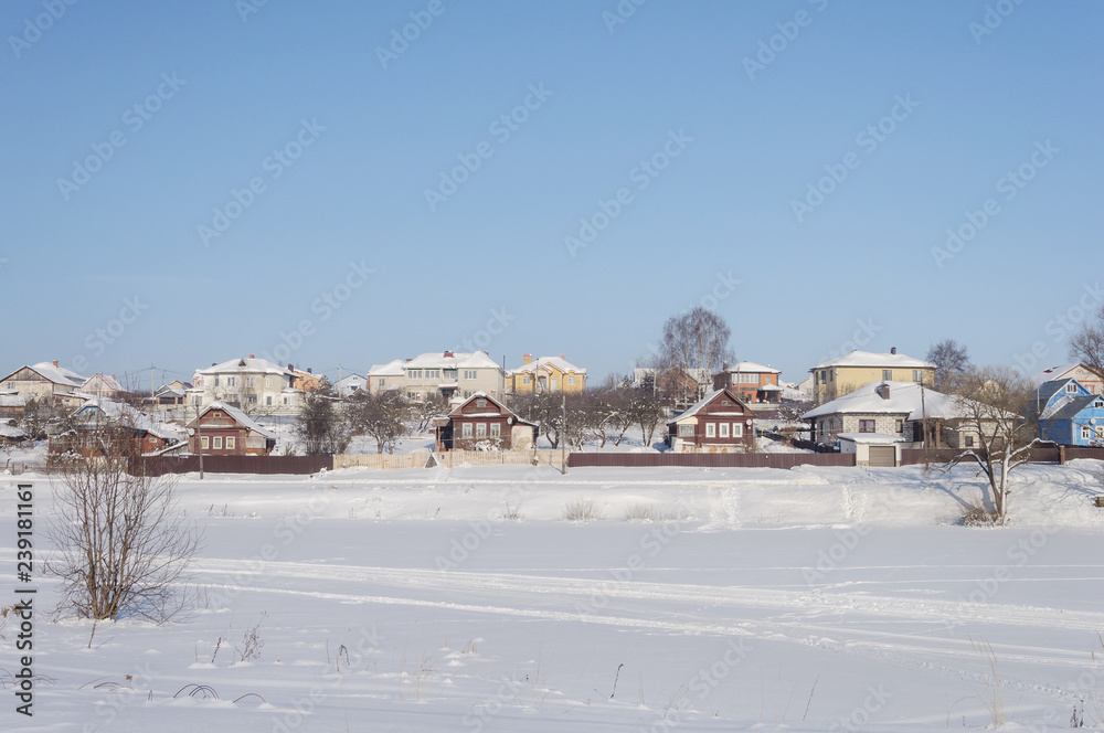 Winter landscape, village by frozen river
