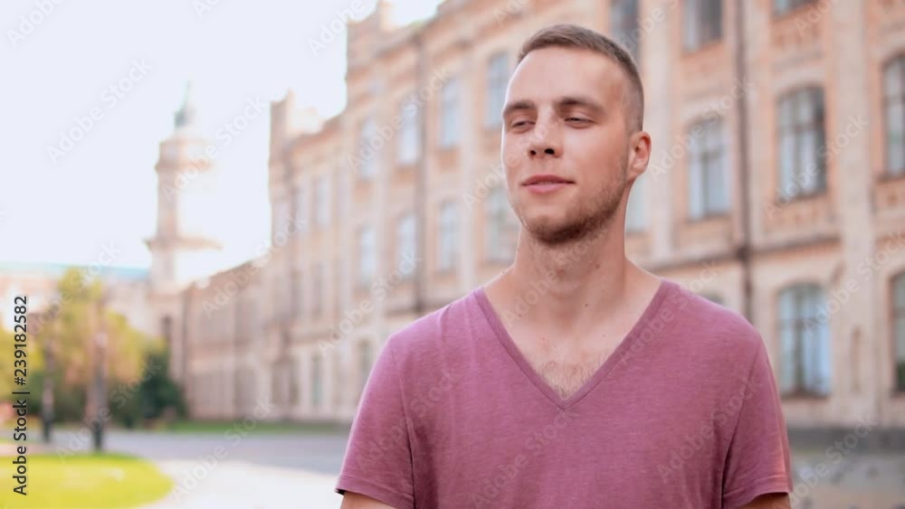 portrait student wearing red t-shirt look around strolling on a sunny day slow motion portrait student wearing red t-shirt look around strolling on a sunny day slow motion