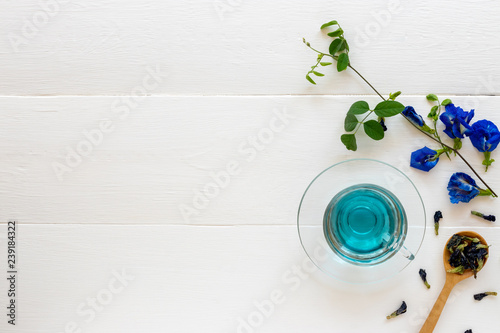 Cup of Butterfly pea flower tea on white wooden background. Health drink concept.