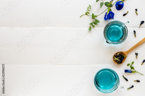 Top view of Butterfly pea flower tea on white wooden background. Health drink concept.