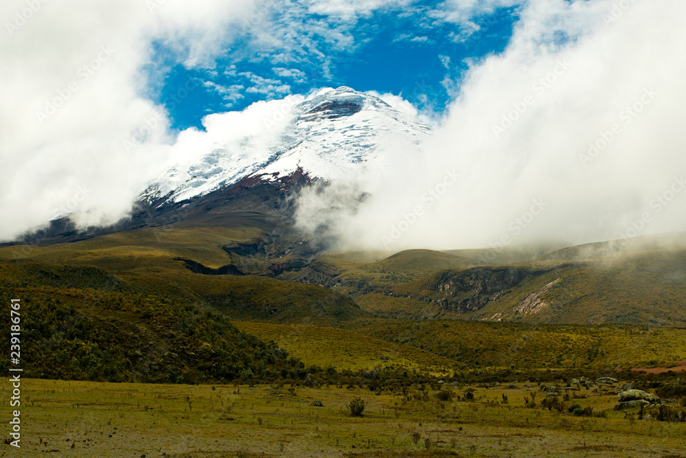 Cotopaxi Volcano in Ecuador covered by snow and clouds 