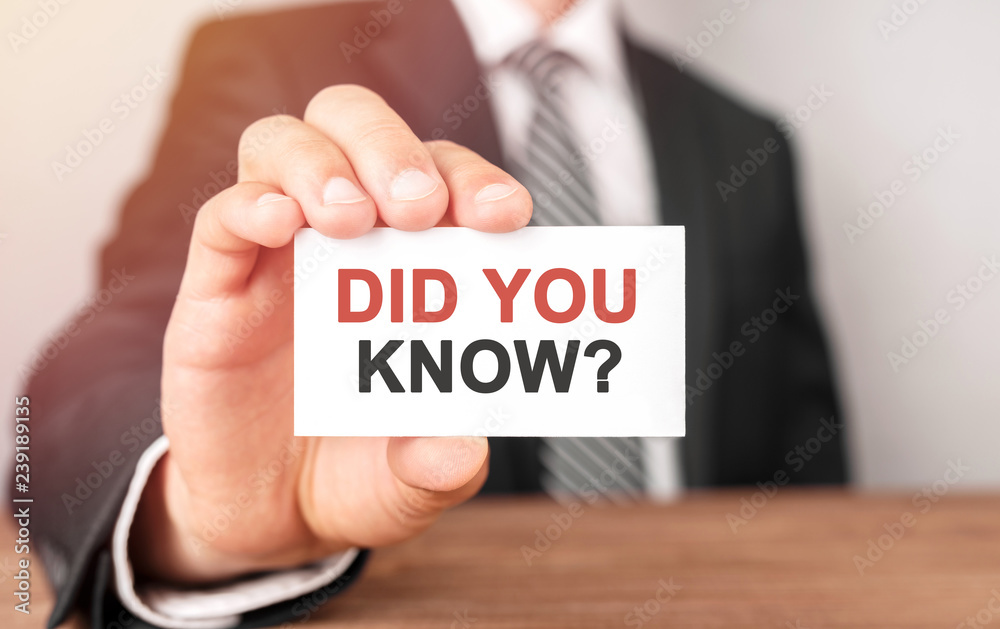Businessman holding a card with text Did you know Businessman holding a card with text Did you know