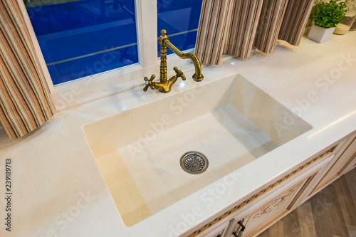 Antique hot and cold tap in the kitchen. Fashionable ceramic sink