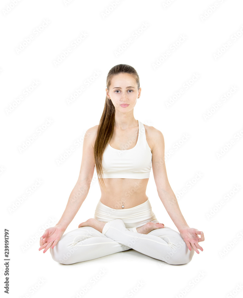 A young woman in a white suit performs acrobatic elements and yoga. A young woman in a white suit performs acrobatic elements and yoga.