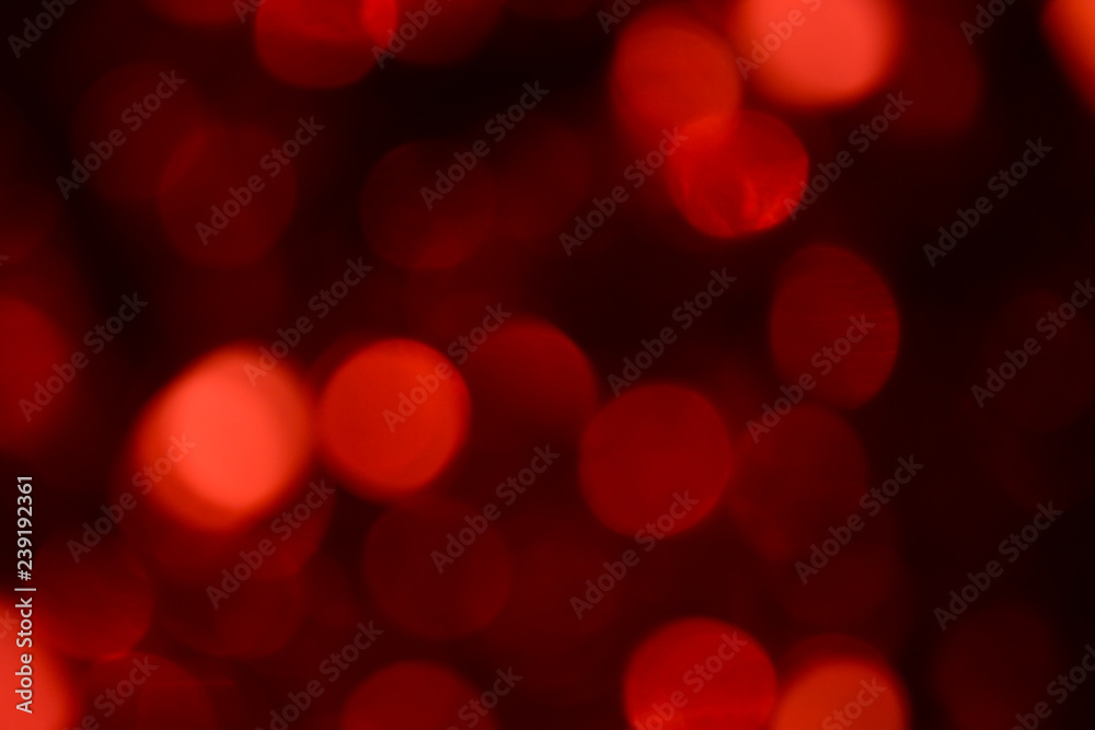 Bokeh. Holiday background. Christmas lights. Glitter. Defocused sparkles. New Year backdrop. Festive wallpaper. Blinks. Carnival. Bokeh retro style photo. Red.
