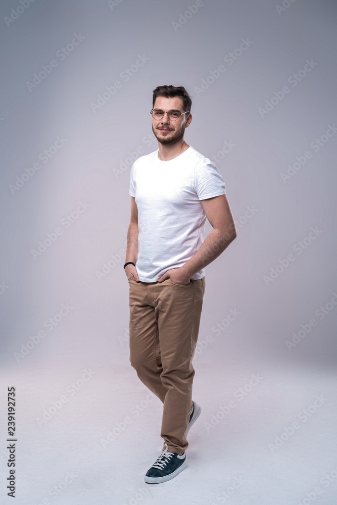 Full length portrait of happy handsome young man isolated on gray background. Full length portrait of happy handsome young man isolated on gray background.