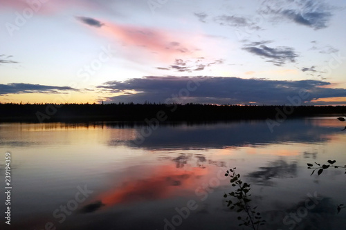 Fototapeta Naklejka Na Ścianę i Meble -  Quiet evening on the northern lake of Karelia. Beautiful sunset. Reserve Wild nature. Silence. Backdrop. Reflection of bright clouds in the water