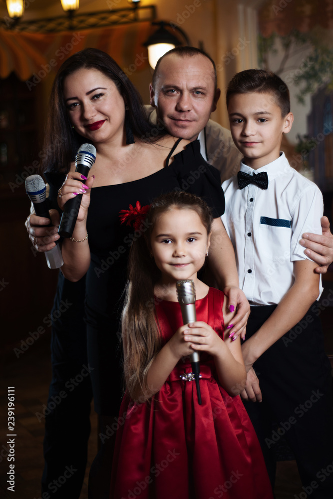 Family karaoke. Portrait of a happy family, singing in microphones