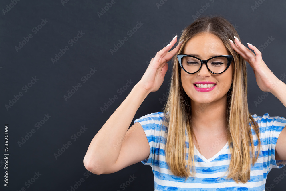 Young woman feeling stressed on a black background Young woman feeling stressed on a black background