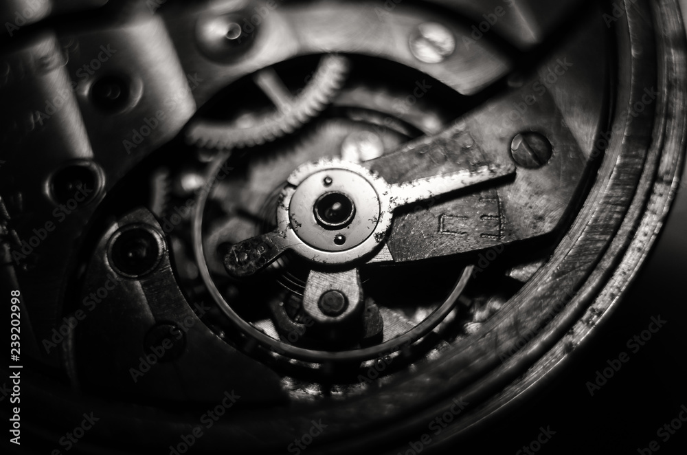 The mechanism of old antique pocket watches, Close up view of old clock's gears. selective focus The mechanism of old antique pocket watches, Close up view of old clock's gears. selective focus